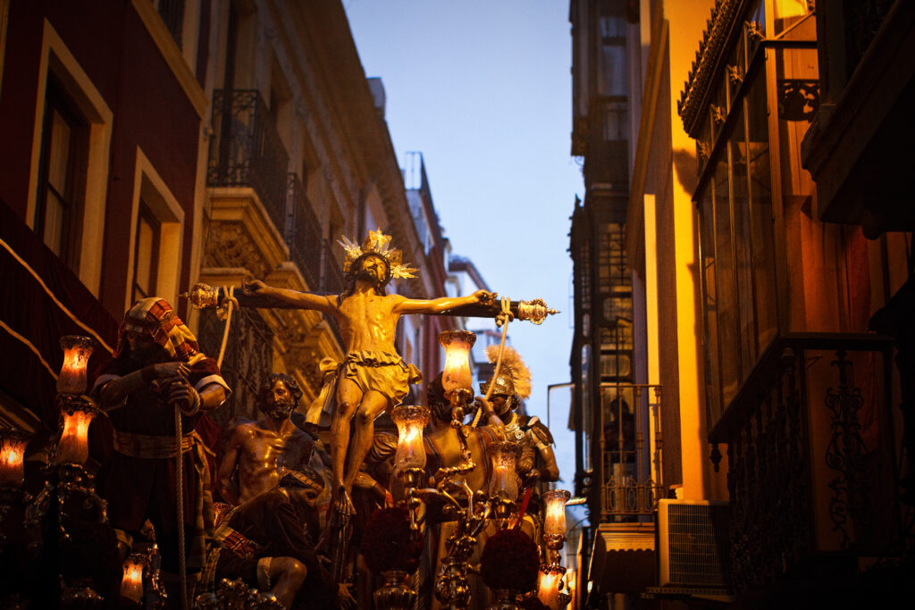 Prozession der Christen bei Abenddämmerung während der Semana Santa in Sevilla.Blick auf einen Wagen. 