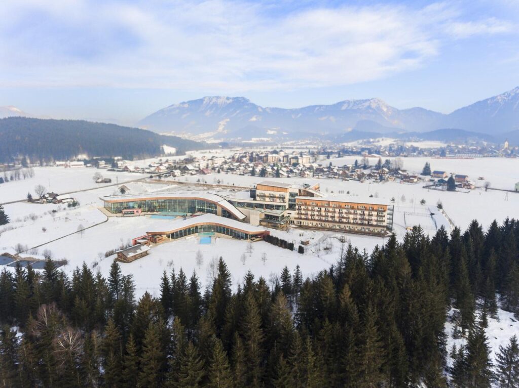 Blick von oben auf den Aldiana Club Salzkammergut im Winter bei Schnee.  